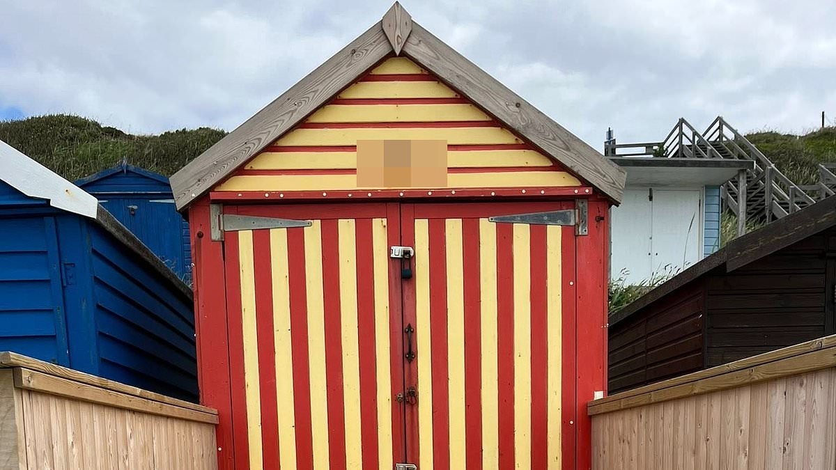 Beach hut owner is embroiled in bitter row with neighbours after 'spoiling popular seafront' with 'ugly' walled fence