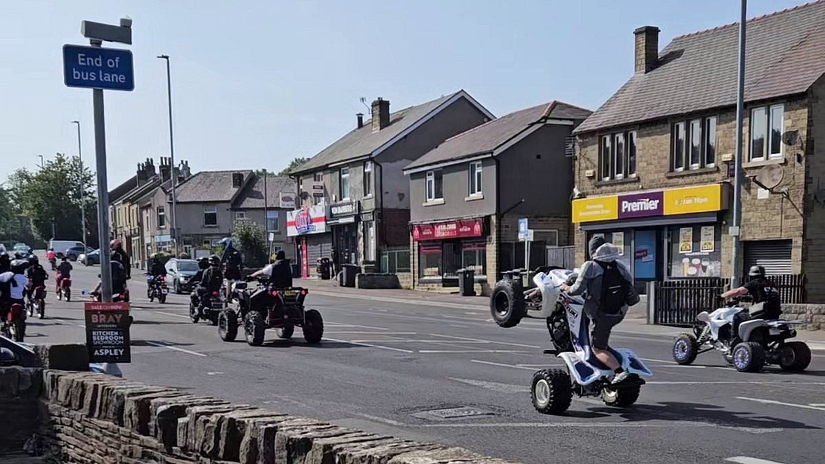 Moment balaclava-clad biker gang do wheelies as they terrorise locals on quiet road