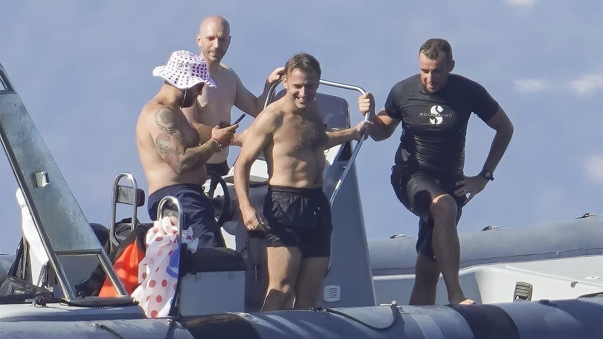 French president Emmanuel Macron makes the most of his summer as he skips over the waves on his jetski... while Brigitte watches on