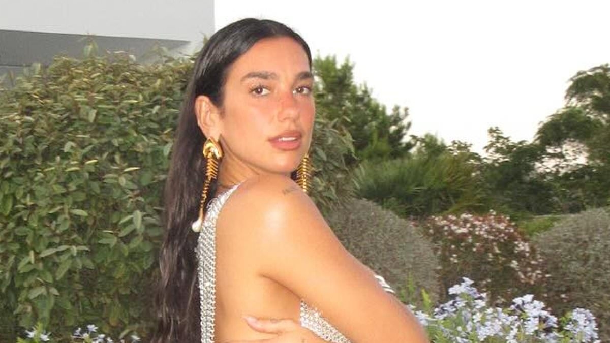 Dua Lipa goes braless in risqué silver sequin dress with daring cutaway as she rings in early birthday celebrations in Ibiza