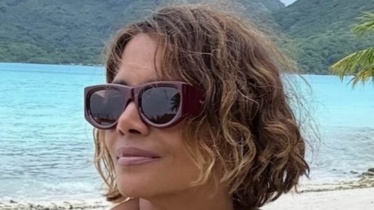 Bikini-clad Halle Berry, 59, looks incredible as she poses for racy beach snaps - after brutally roasting ex David Justice