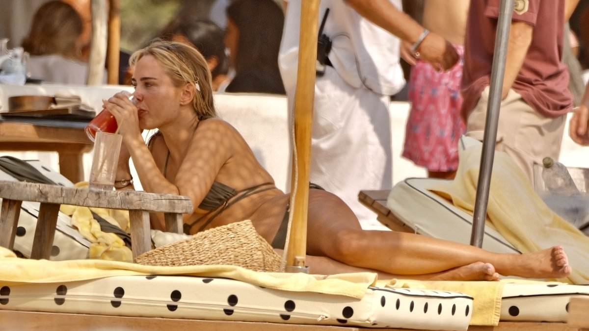 Kimberley Garner flashes her jaw-dropping figure in a tiny brown bikini as she soaks up the sun in Ibiza