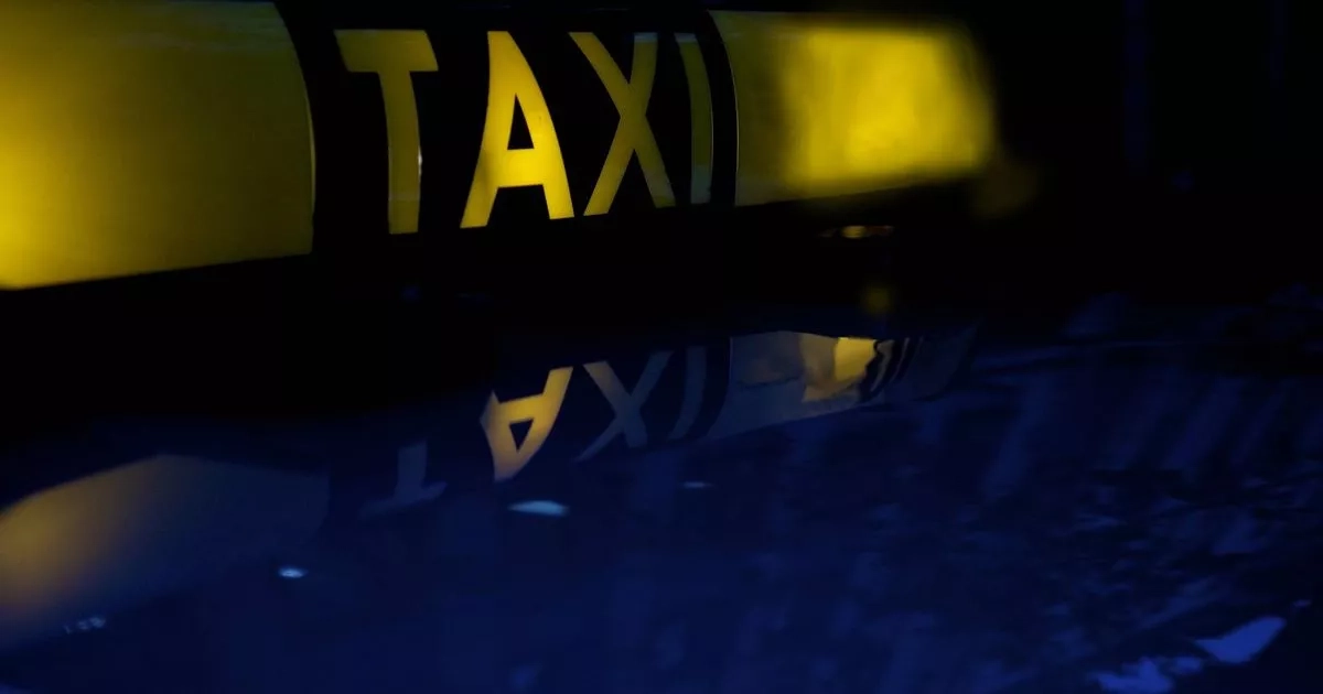 Taxi carjacked by armed masked man with passenger in back seat