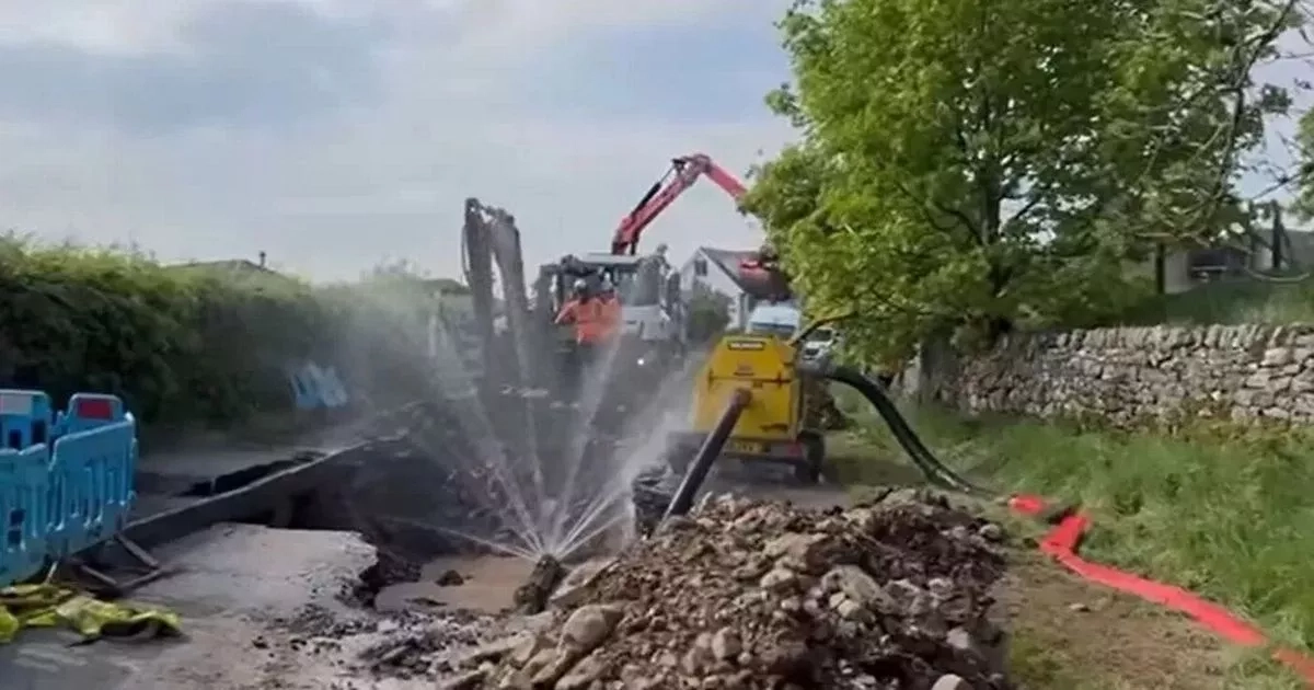 Huge sinkhole suddenly emerges in road leaving locals without water
