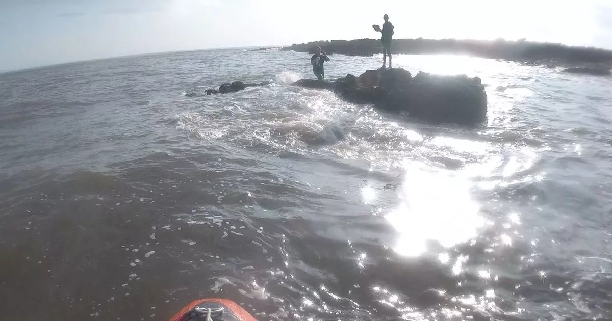 Teenagers rescued after getting stuck on rock as water rose around them