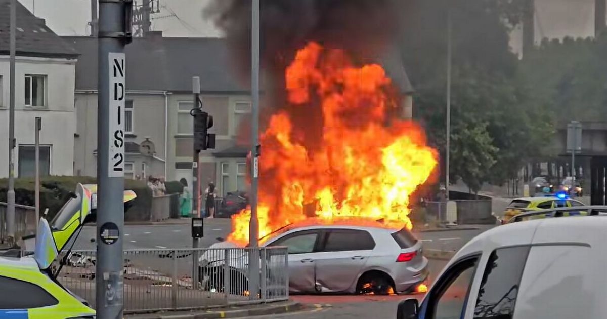 Dramatic footage shows crowds gather as car erupts into '30ft' flames