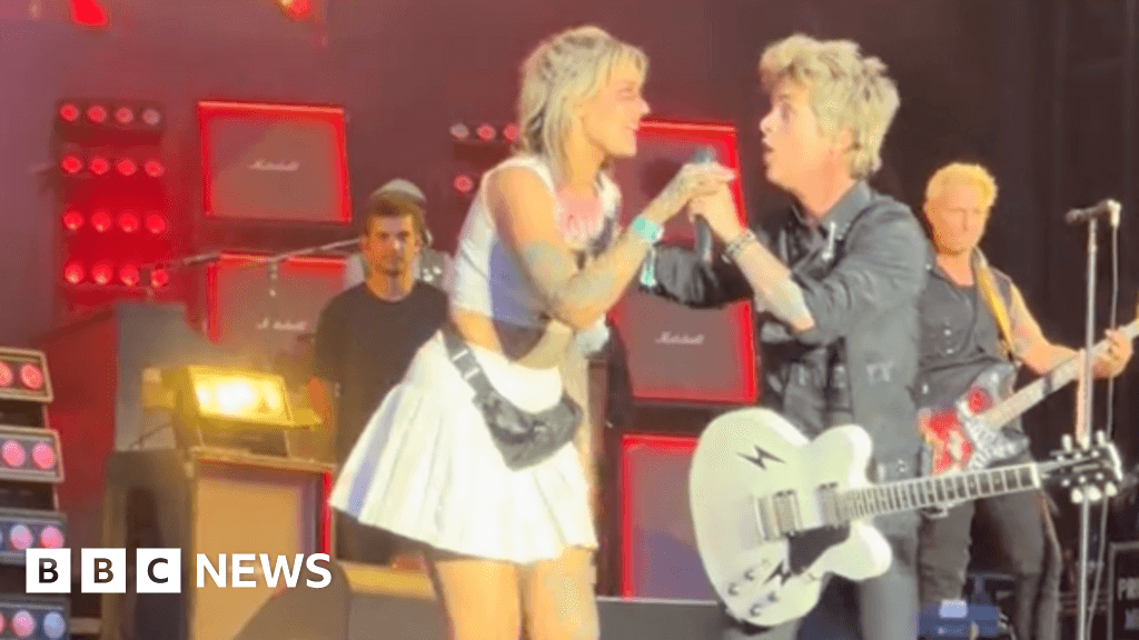 Woman sings on stage with Green Day at Download Festival