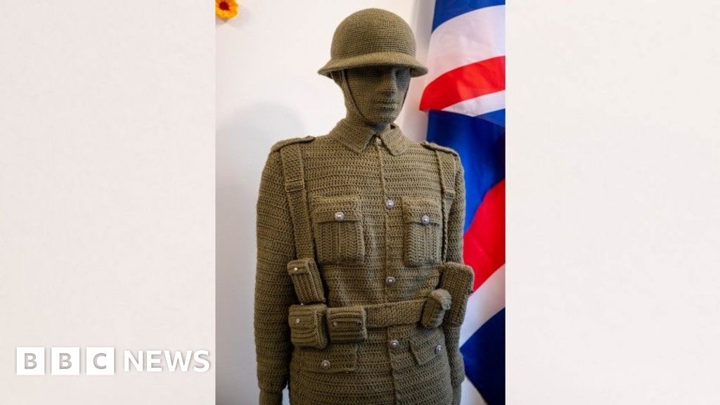 Maker of 6ft crochet soldier honoured at Buckingham Palace