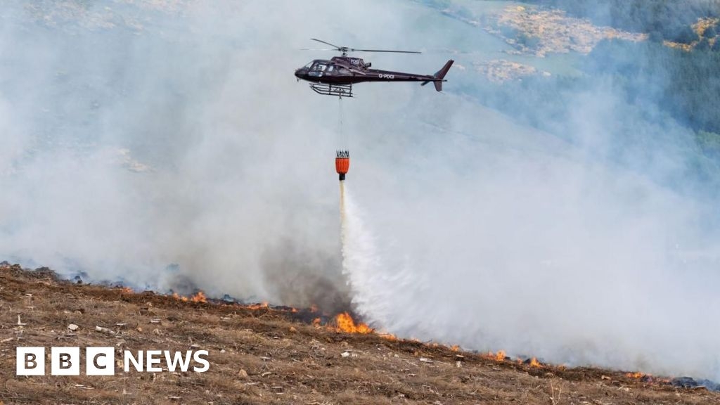 Firefighters and helicopter tackle wildfire near Alford