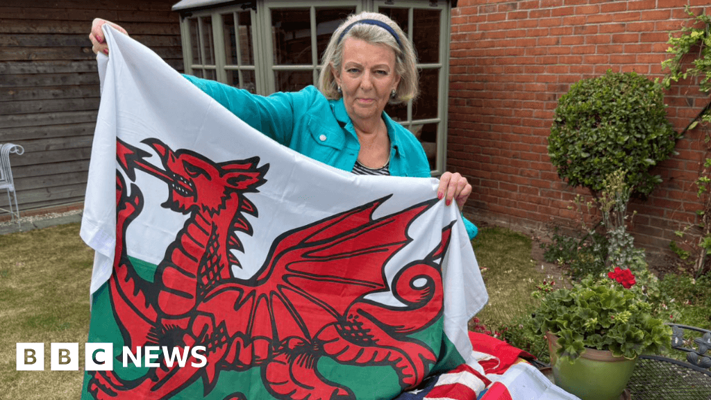 Flag lady raising the standards in her village