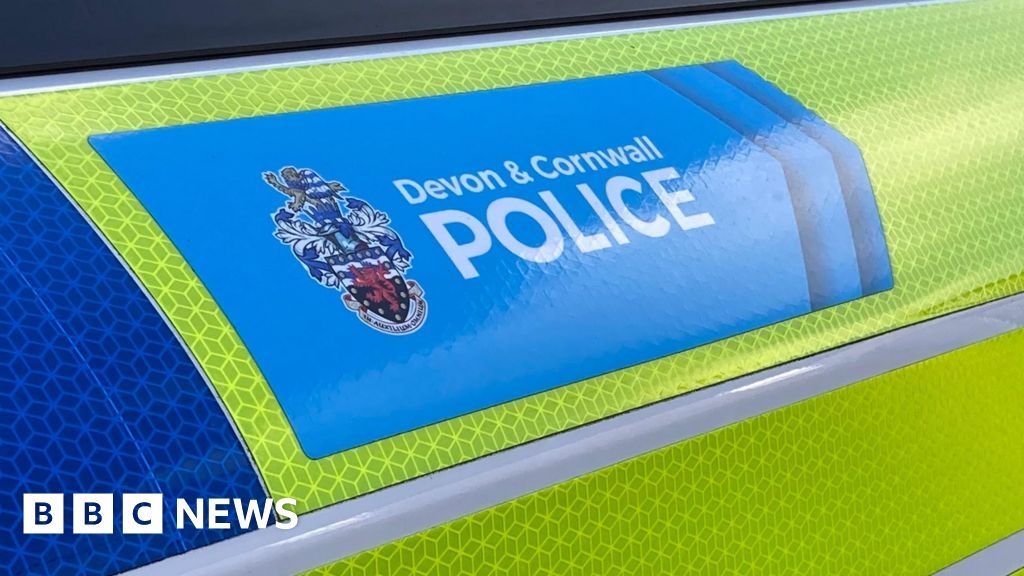 Man, 51, charged after body found in Devon flat