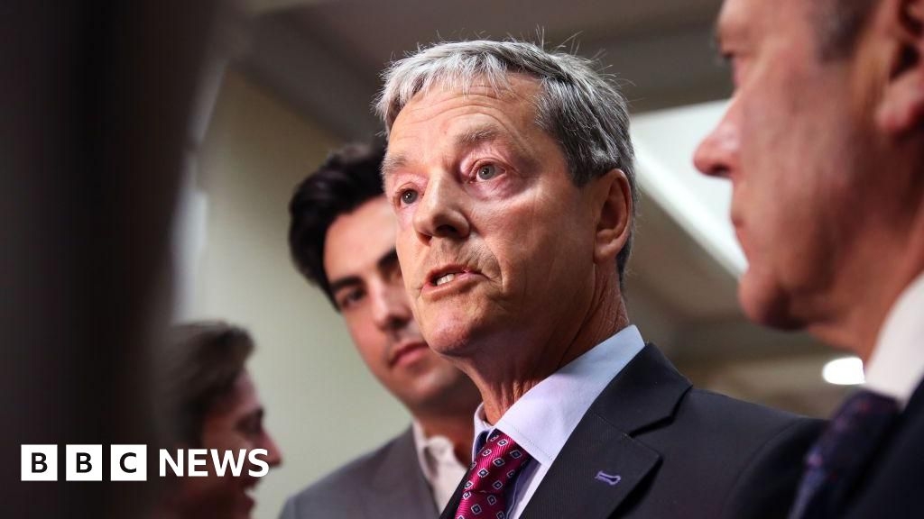 Andrew Bayly: NZ minister resigns for placing hand on staff's arm