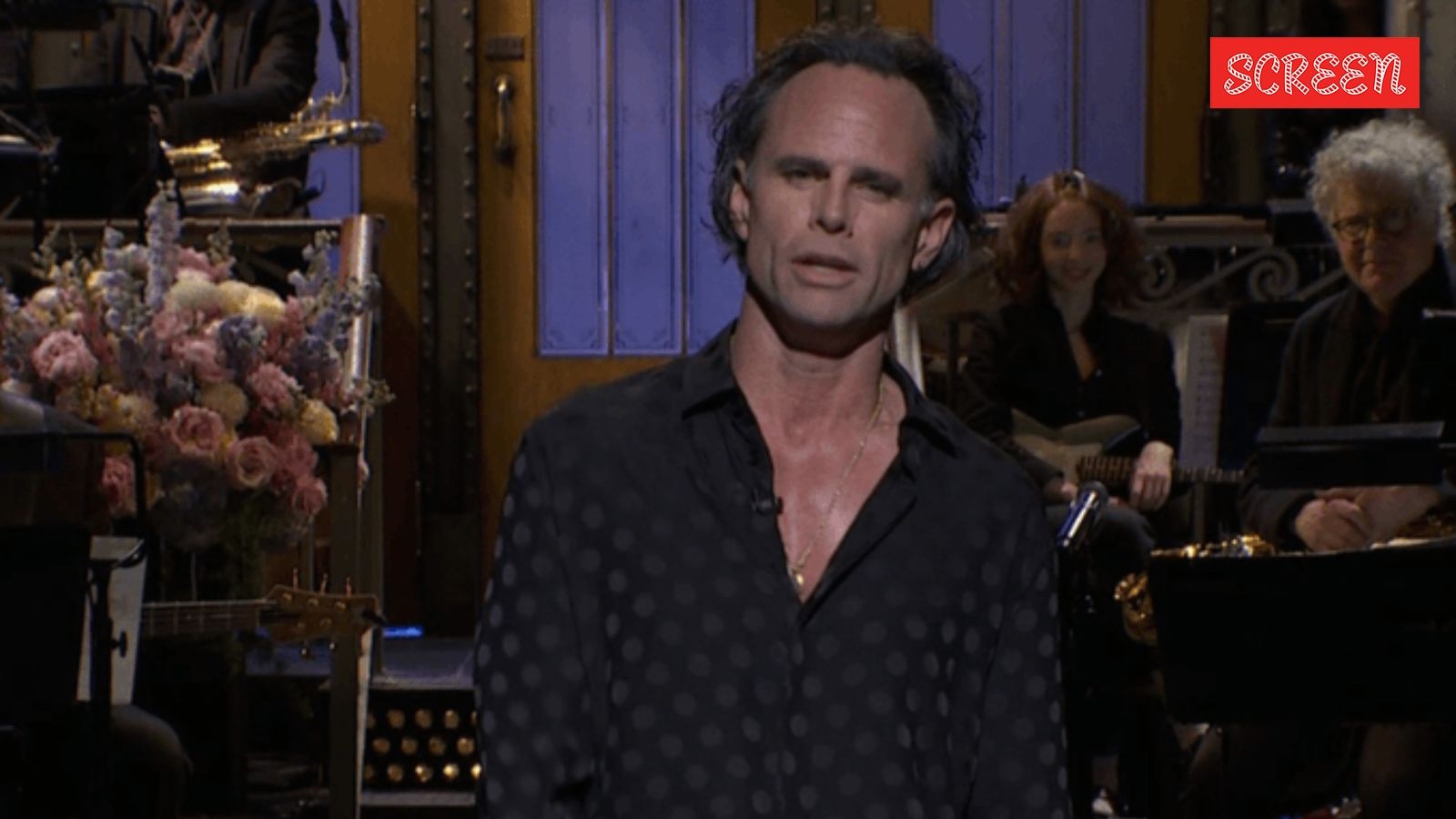 White Lotus star Walton Goggins flaunts his newfound sex symbol status on SNL, jokes about his receding hairline