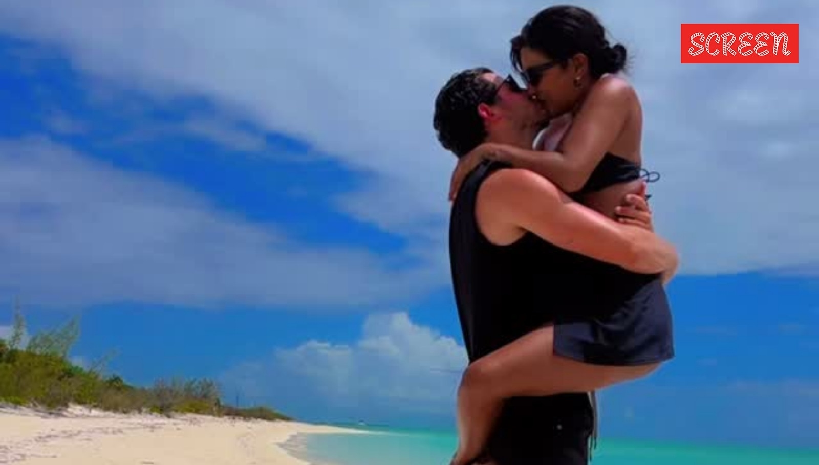 Priyanka Chopra races into Nick Jonas' arms for a kiss on the beach in PDA-filled new video. Watch here