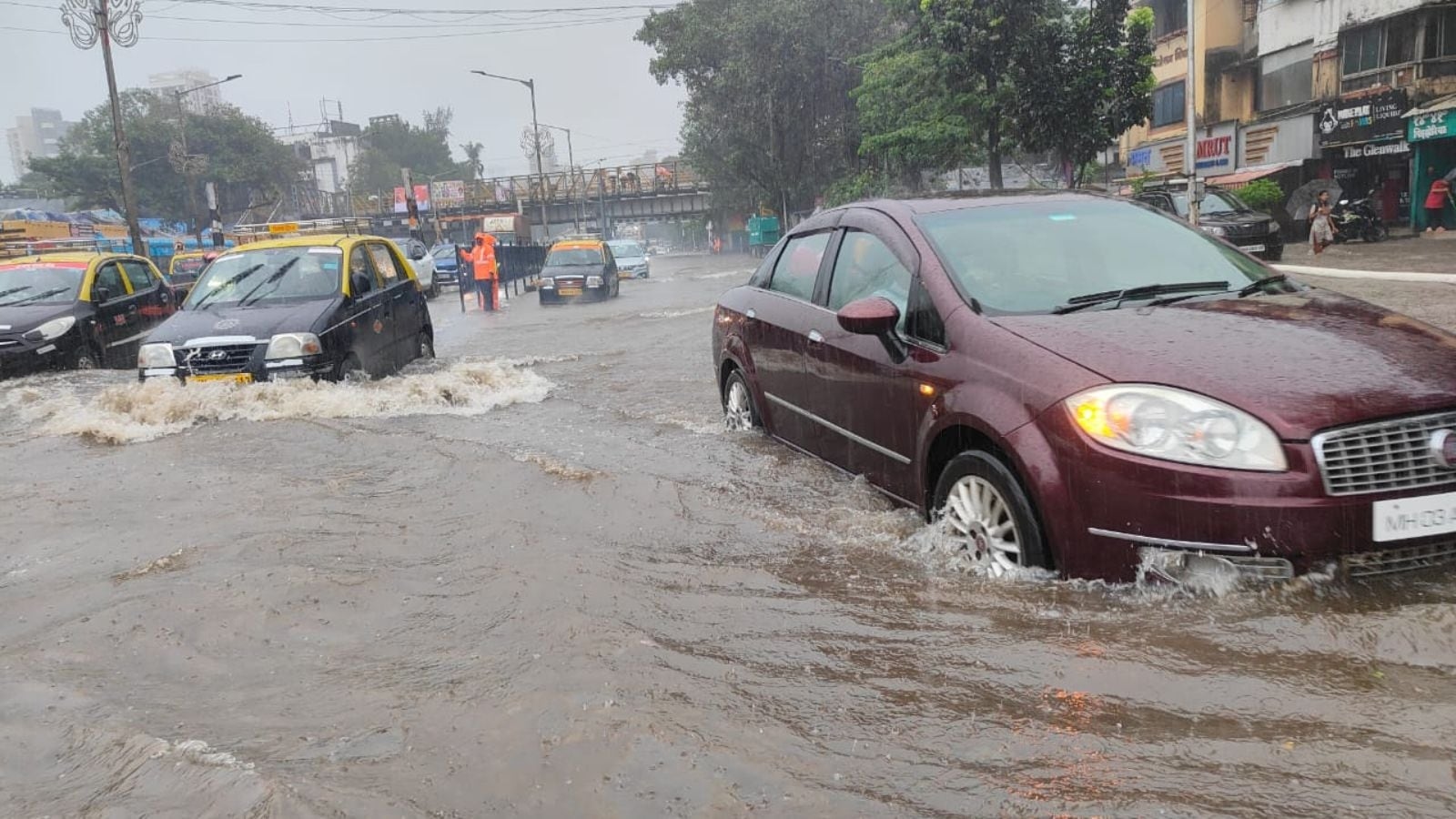 Trains running late, roads waterlogged as overnight rain batters Mumbai; IMD issues red alert until noon