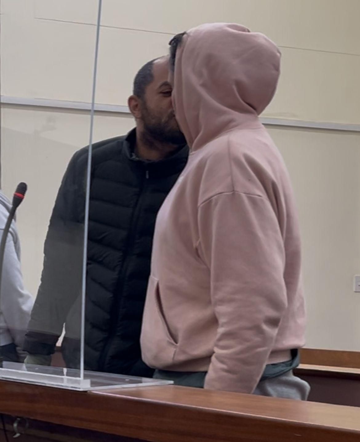 Passion in the dock: Accused share a kiss before dropping bail bid