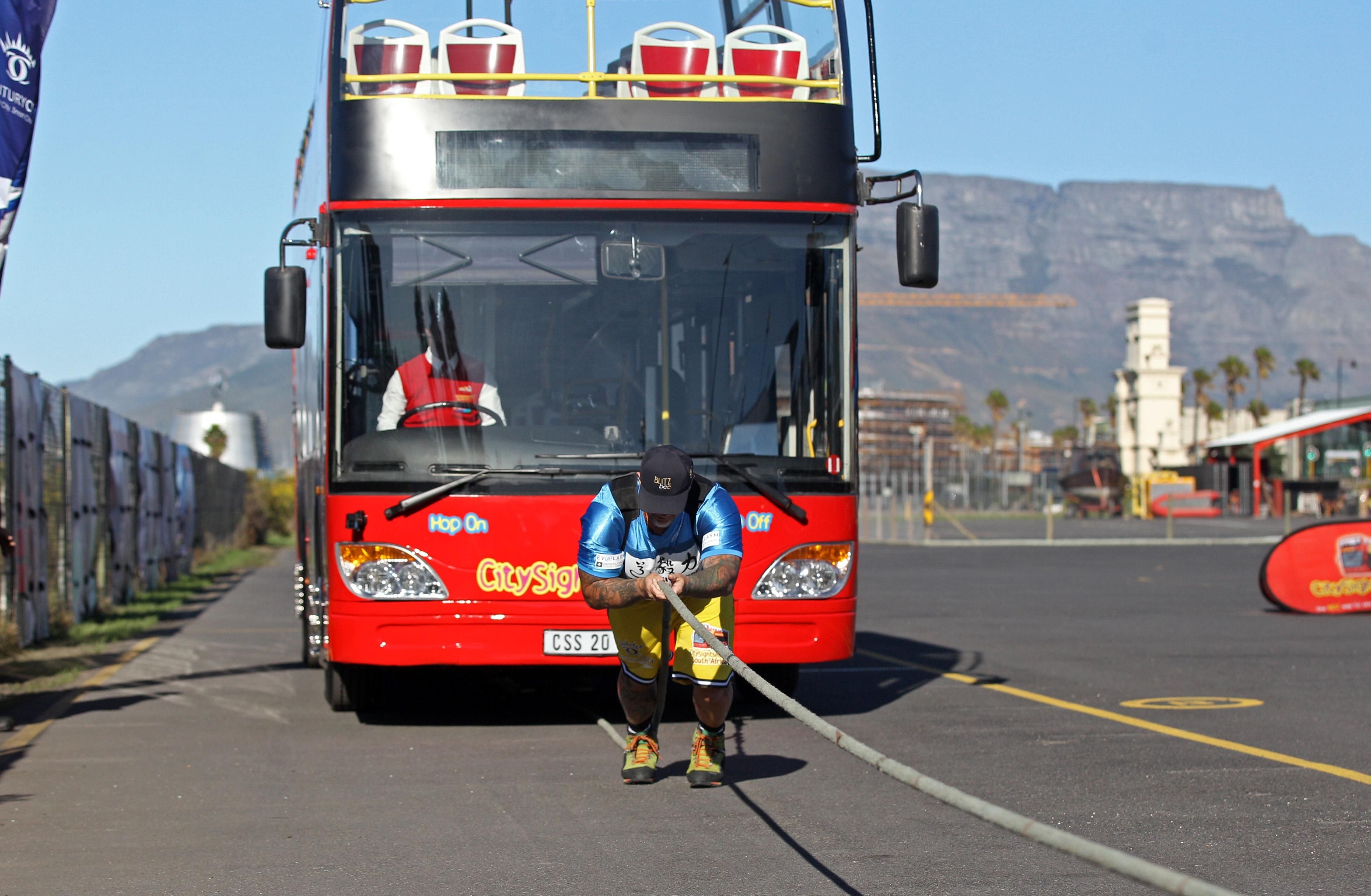 Franz Müllner sets world record by pulling a double-decker bus in Century City