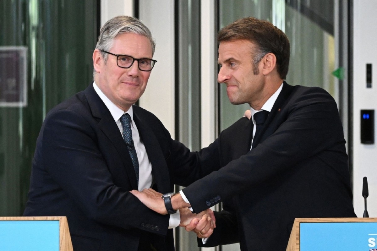UK, France unveil migrants deal as Macron ends visit