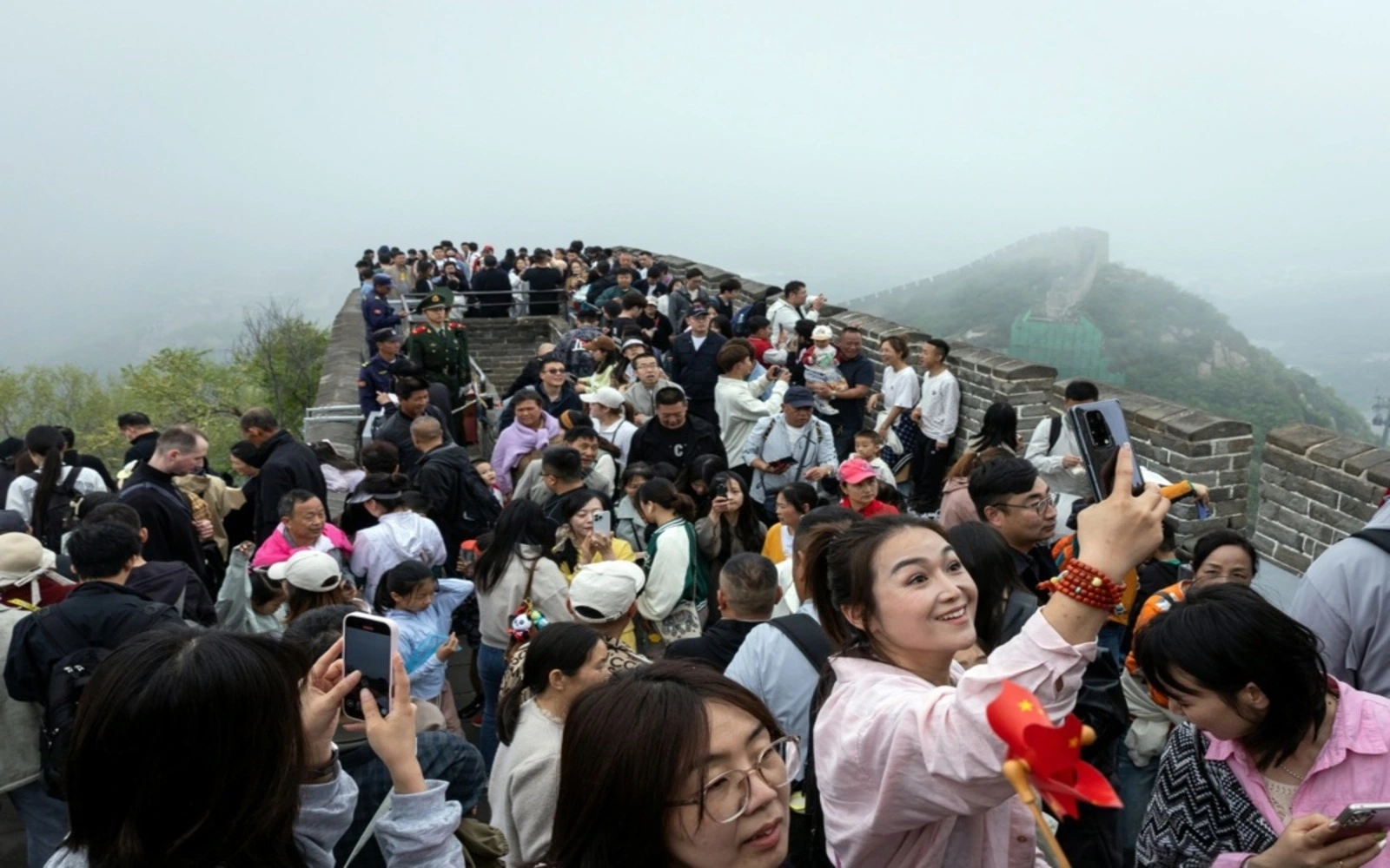 Chinese holiday spending inches up, but trade war weighs on services