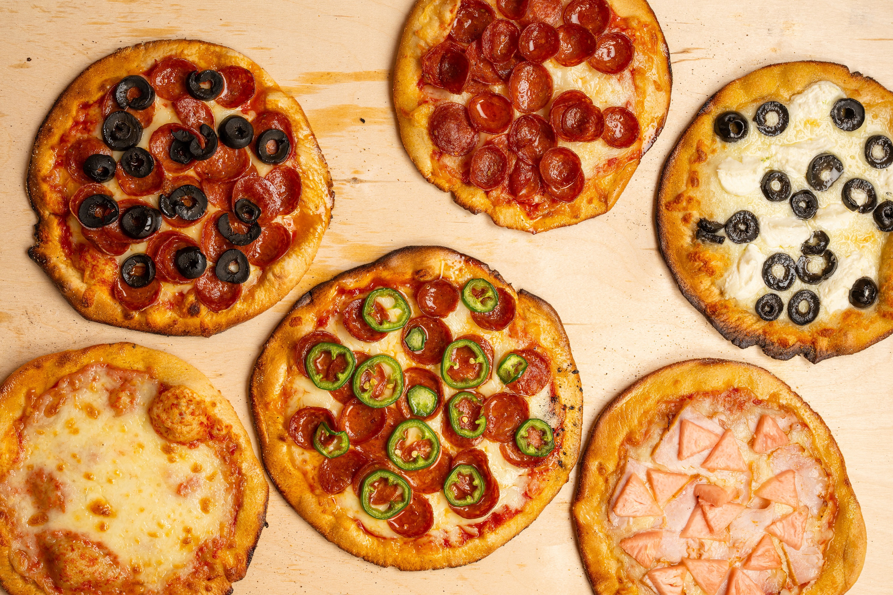 A new midtown shop is putting pizza on a flattened bagel—and we're into it