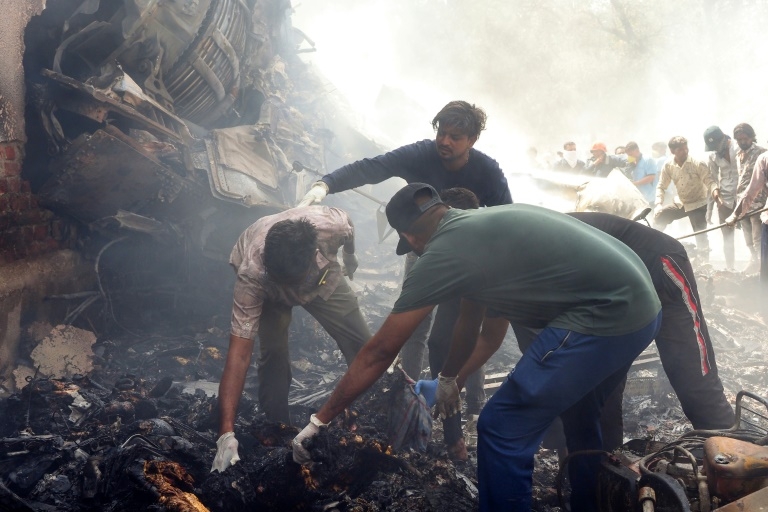 Flames and smoke in aftermath of crashed India passenger jet