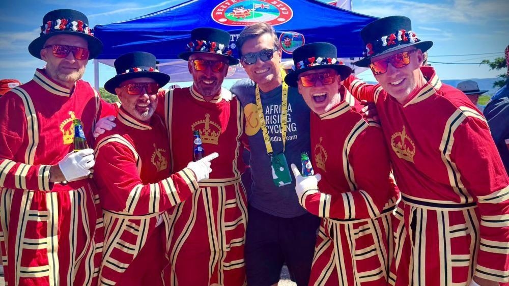 Friends dress as Beefeaters to cheer on cyclists
