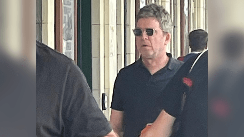 Noel Gallagher arrives for Oasis gig by train