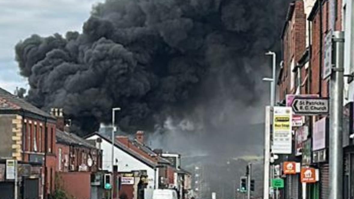 Fire causes huge plume of black smoke above town