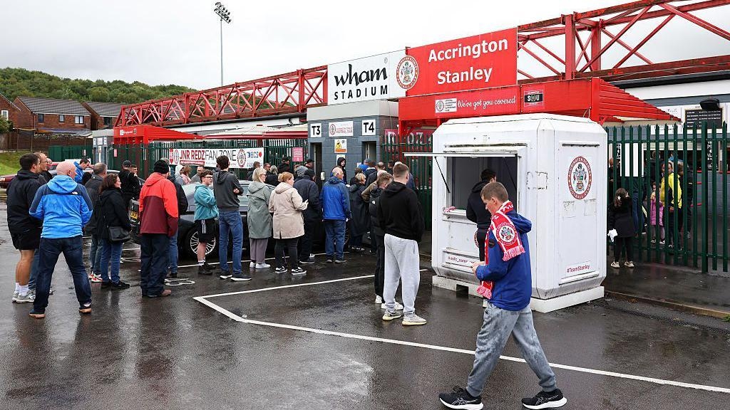 Everton fans brave 'biblical rain' in draw at Accrington
