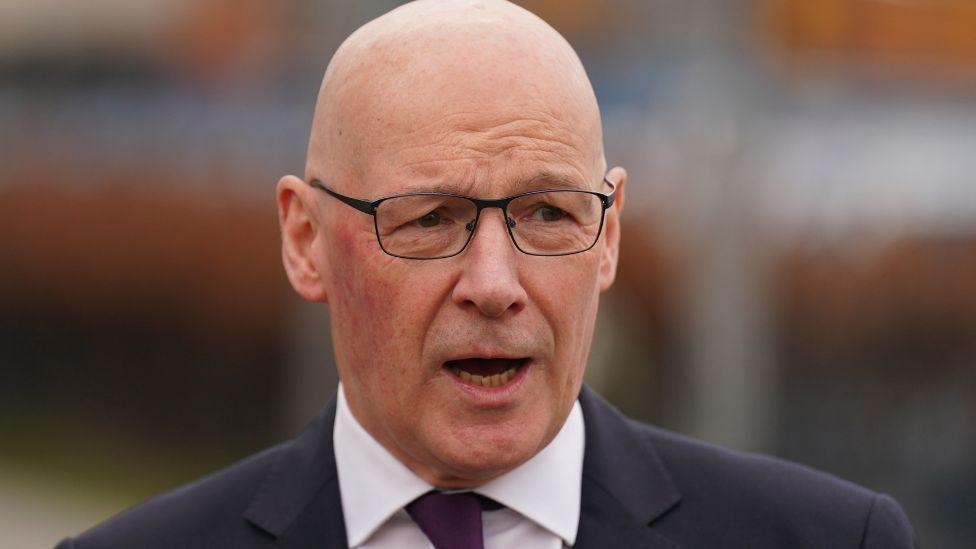 Swinney accuses Reform of racism over Sarwar advert