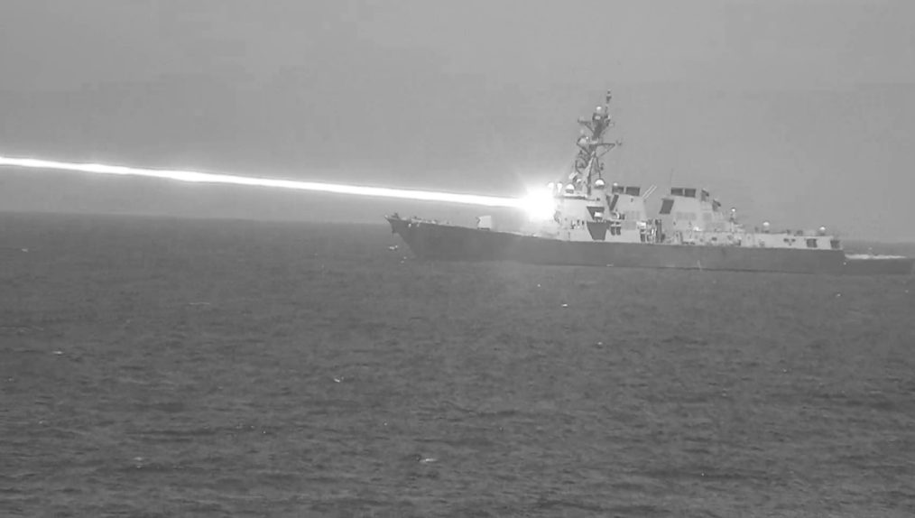 U.S. Navy unveils photo of warship firing high-powered laser weapon