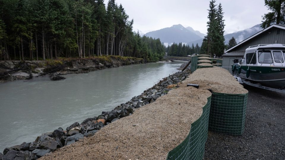A glacier outburst sent a surge of water downstream into Juneau. Flood barriers protected the city from disaster