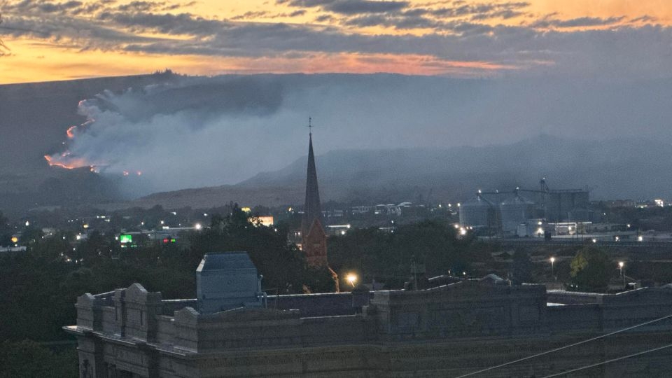 Out-of-control Oregon wildfire forces evacuations and highway closures as gusty winds challenge firefighters