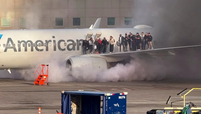 Passengers evacuate onto wing of plane after engine catches fire at Denver Airport