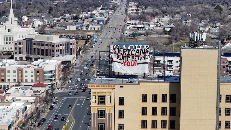 Trump foes breach security of 13-story Ogden building, fly signs critical of the president