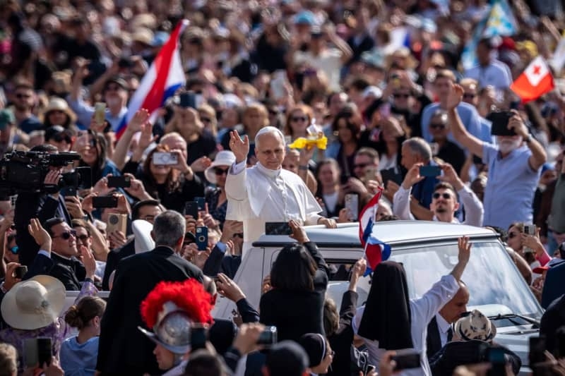 Leo XIV greets crowd from popemobile as he heads for inaugural Mass