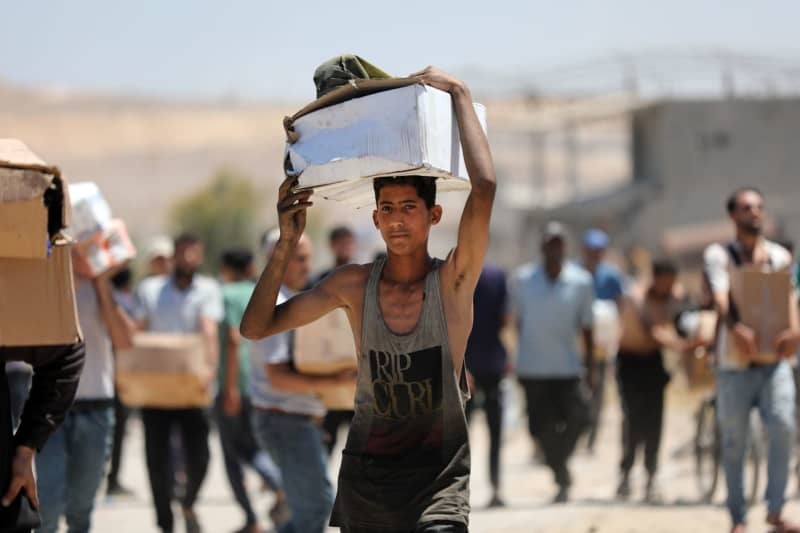UN agency says 77 trucks with aid goods were stormed in Gaza