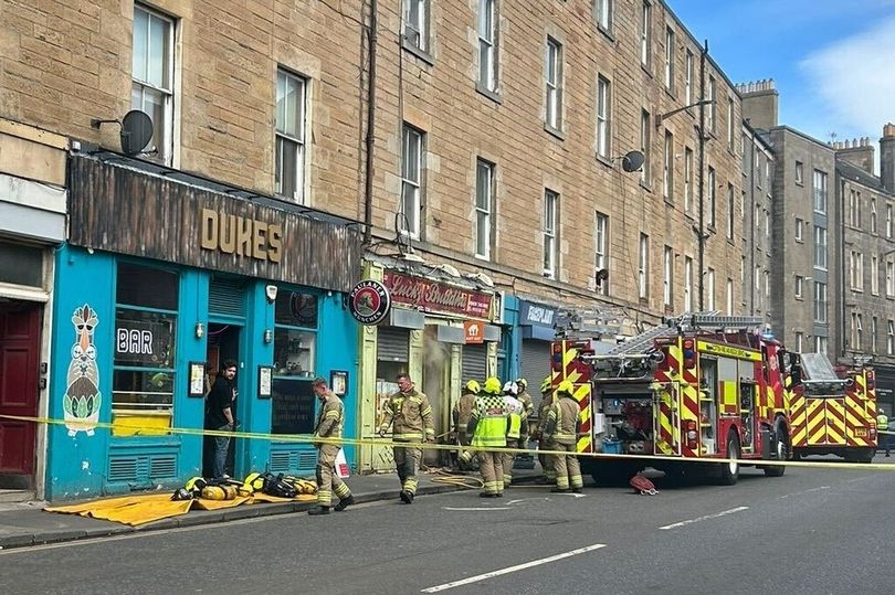 Edinburgh fire crews 'using axes to break down wall' after blaze breaks out at takeaway