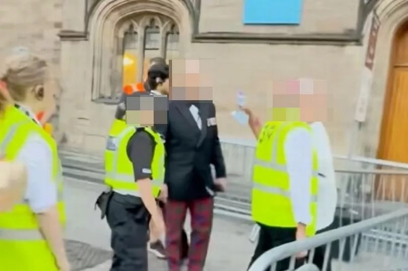 Moment Edinburgh official in tux and bow tie confronts man at Tattoo barricades