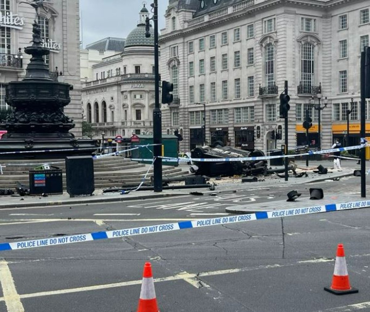 Car flips onto roof after smashing into Piccadilly Circus roundabout leaving two injured