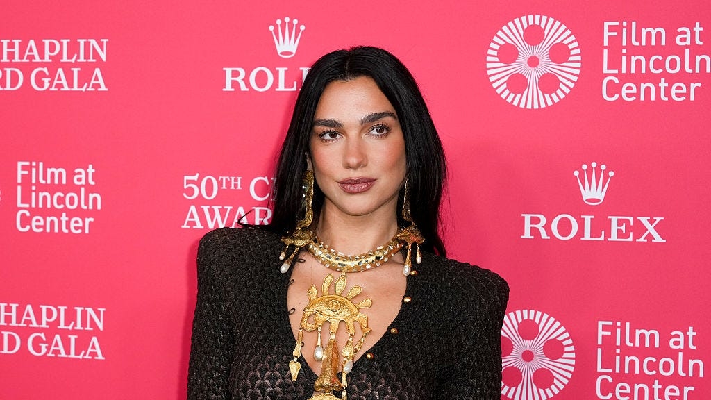Dua Lipa's Mesh Dress Lets Her Belly Button Ring Peek Through