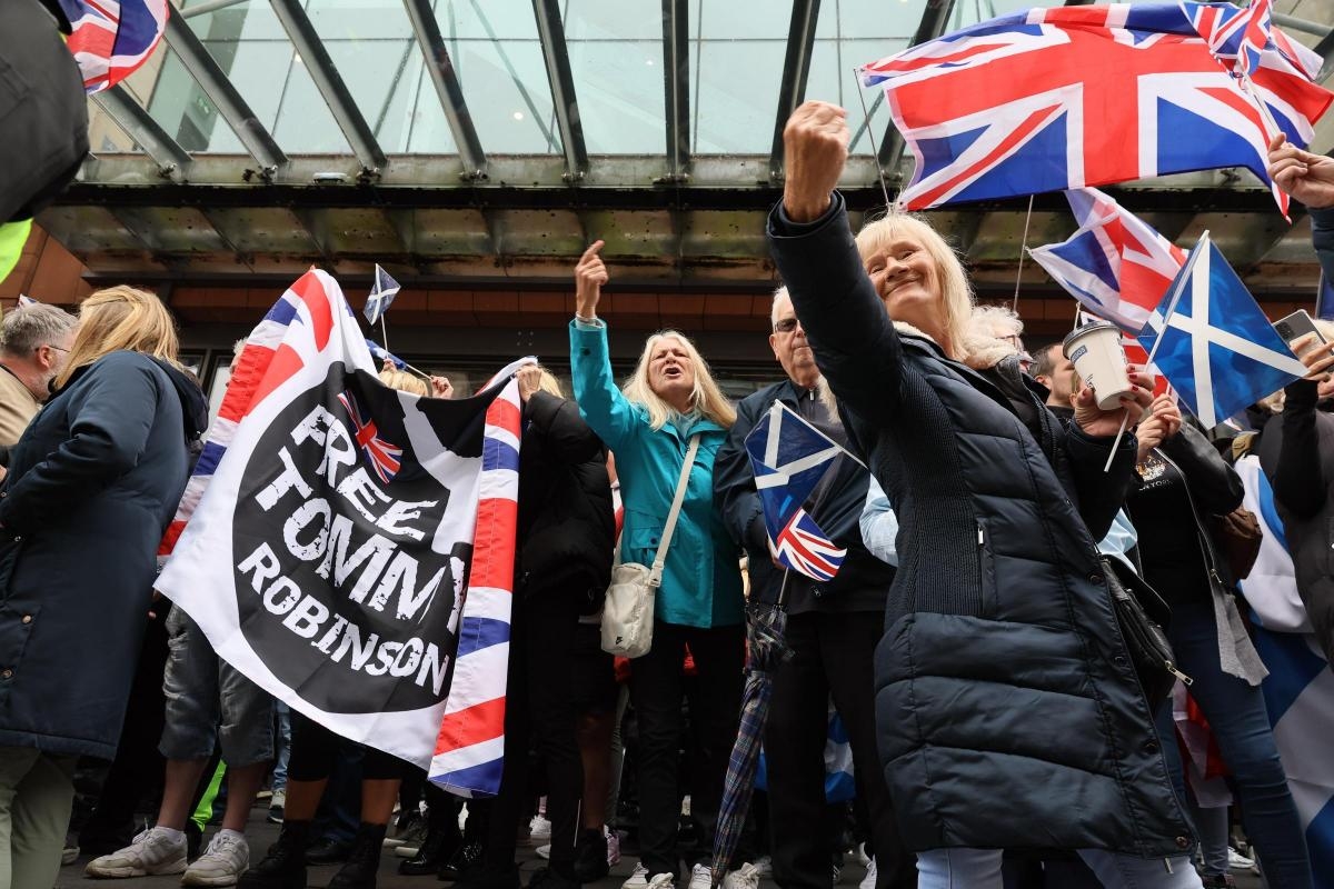 Pictured: 'National strike' and anti-racism protestors separated by police in Glasgow