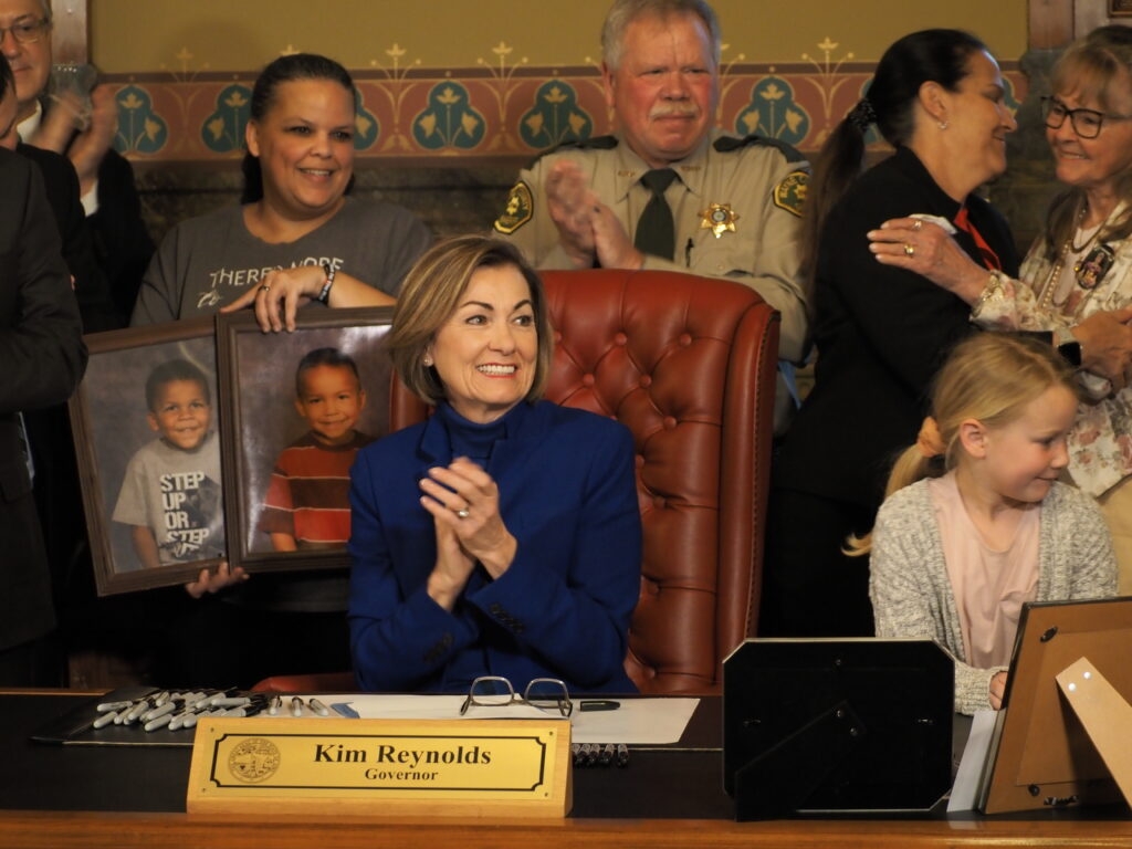 Gov. Kim Reynolds signs ban on handheld cellphone use while driving