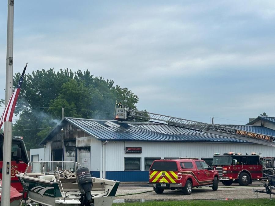 Part of roof collapses during fire at Dakota City boat dealer
