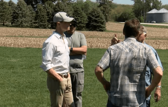 Iowa Auditor Rob Sand visits with farmers in Aurelia