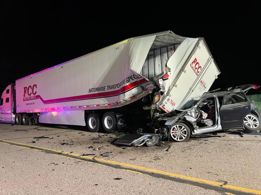 Woman injured, extricated after crashing into parked semi