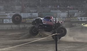 Wheel detaches from monster truck during show, lands on car in parking lot