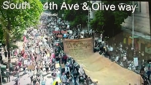 Tens of thousands march to Seattle Center, protesting in ‘No Kings' rally