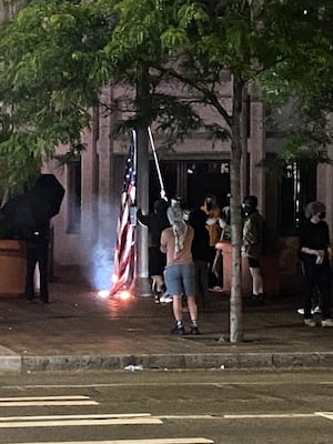 Flag burning outside a barricaded Seattle federal building