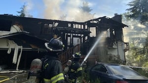 Firefighters evacuate burning home after roof partially collapses